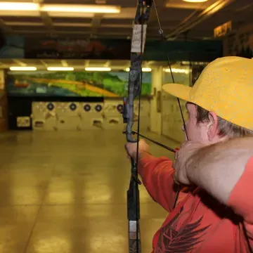 Archery range, man shooting bow at targets